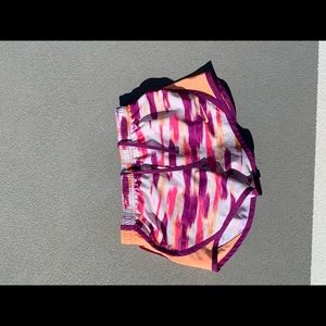 pink, red, and orange brush stroked Nike Shorts